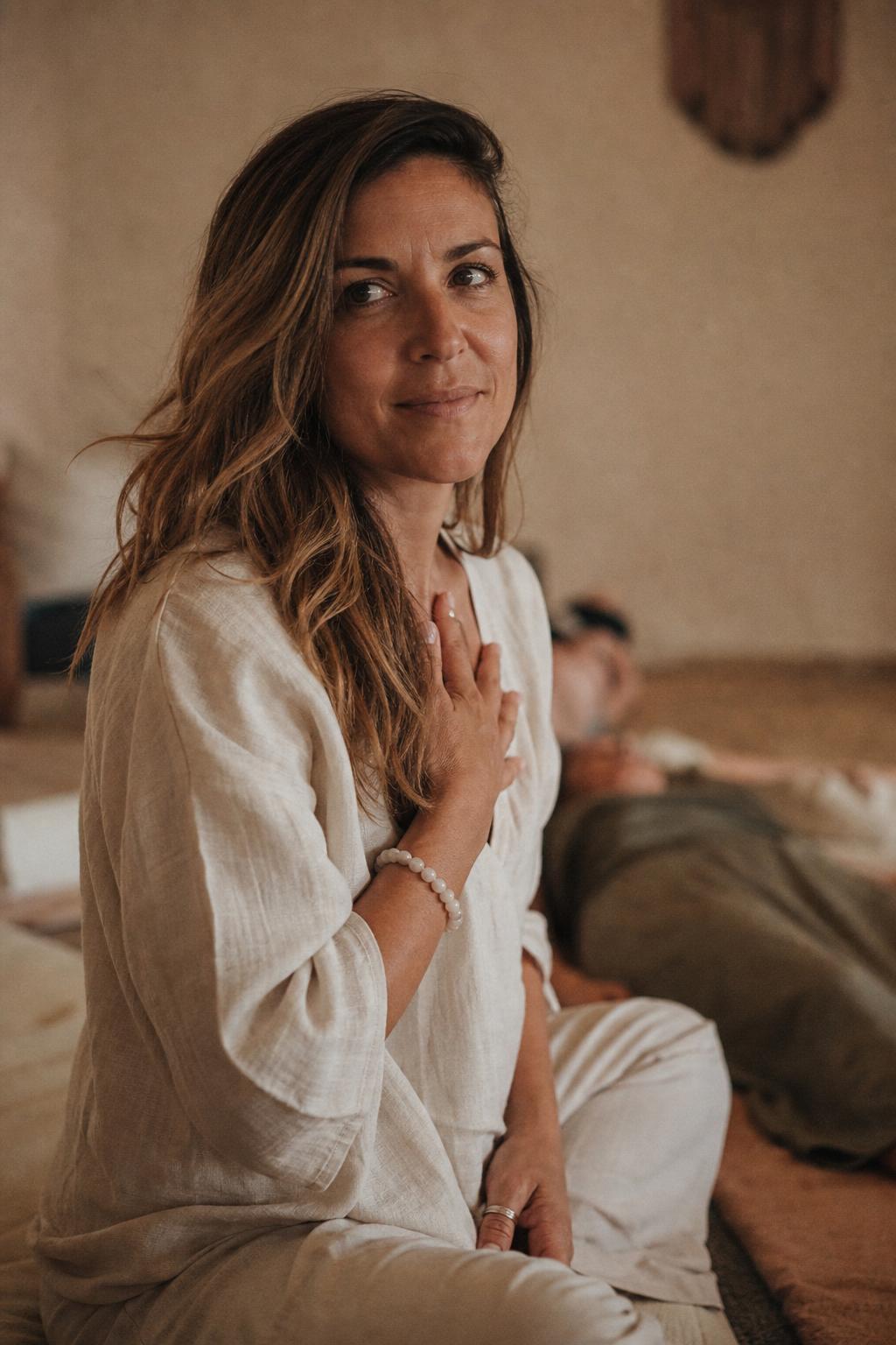 Portrait of a calm breathwork facilitator in a warm, naturally lit space